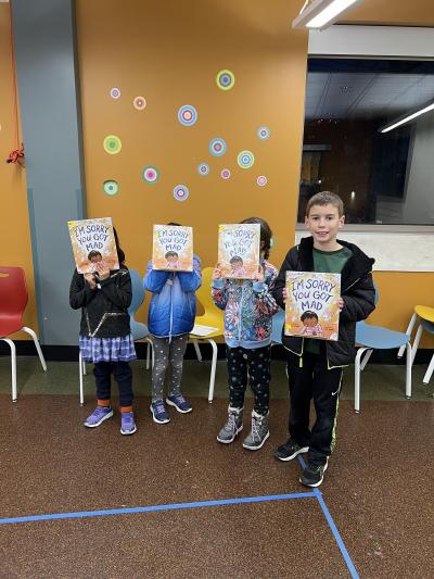 children holding the winner of the Caldecott Club program 